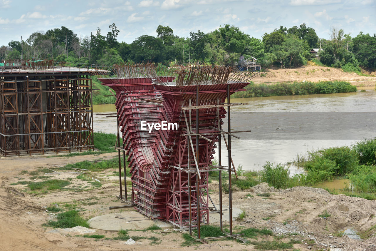 METALLIC STRUCTURE ON FIELD AGAINST SKY