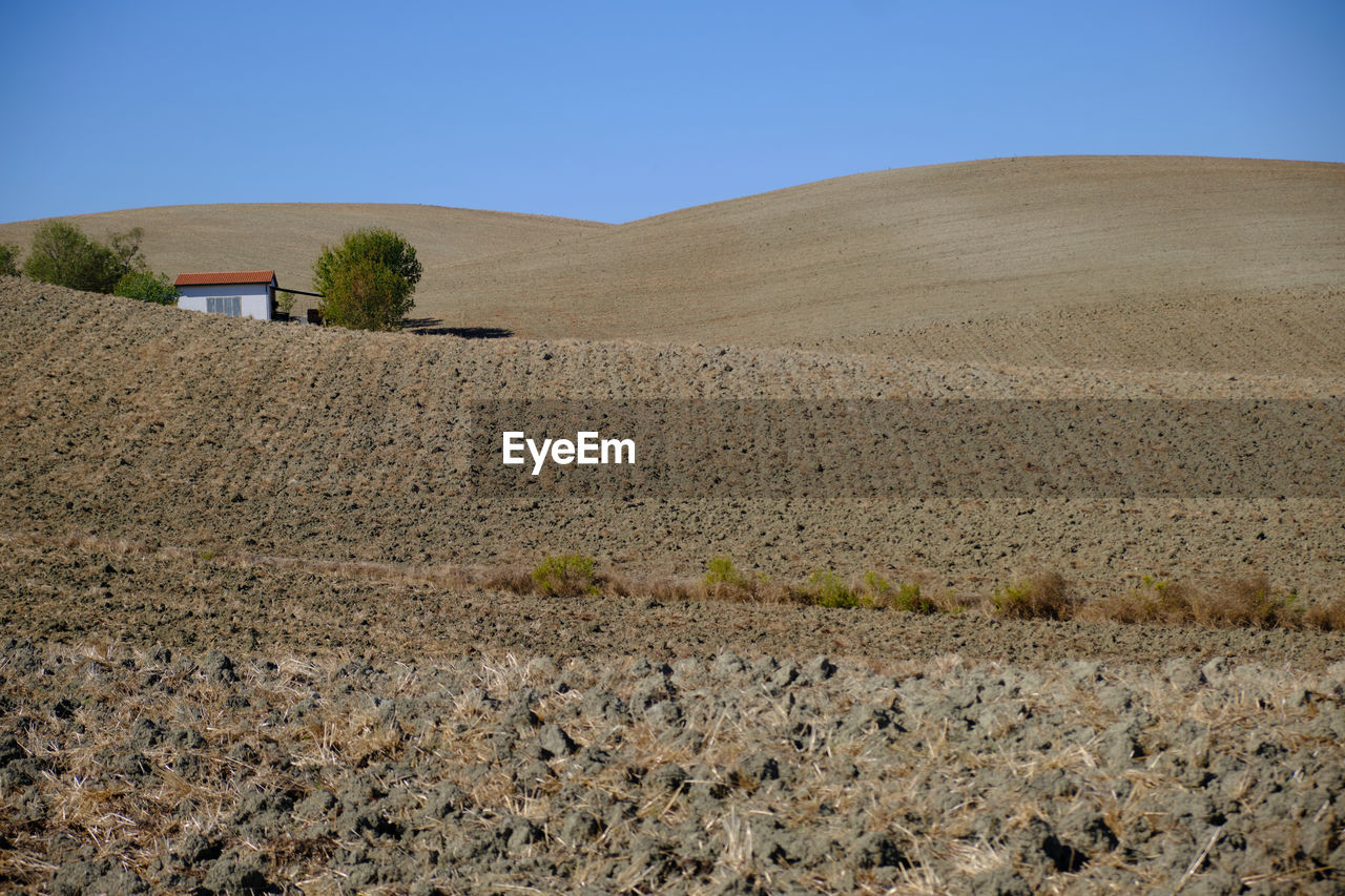 SCENIC VIEW OF ARID LANDSCAPE AGAINST CLEAR SKY