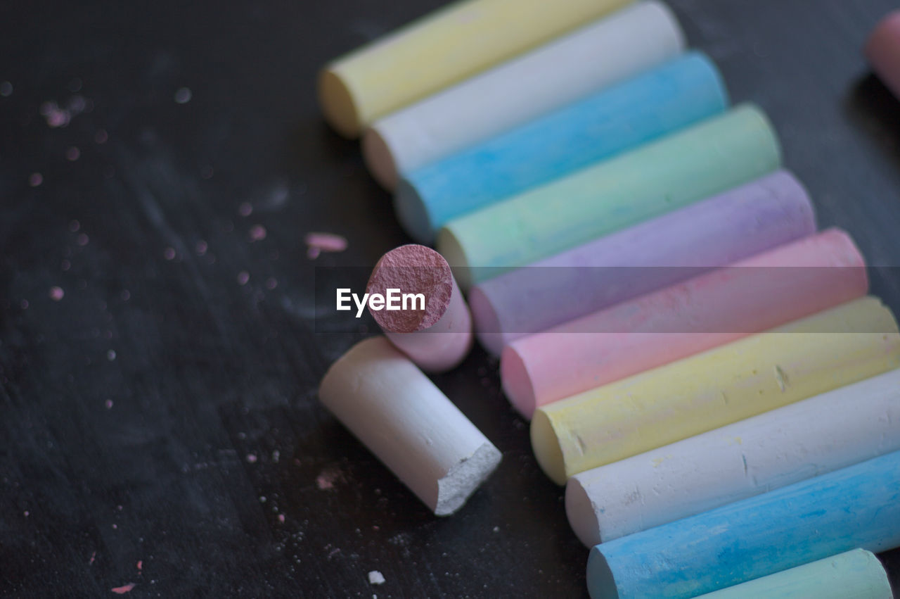 Close-up of colorful chalks on table