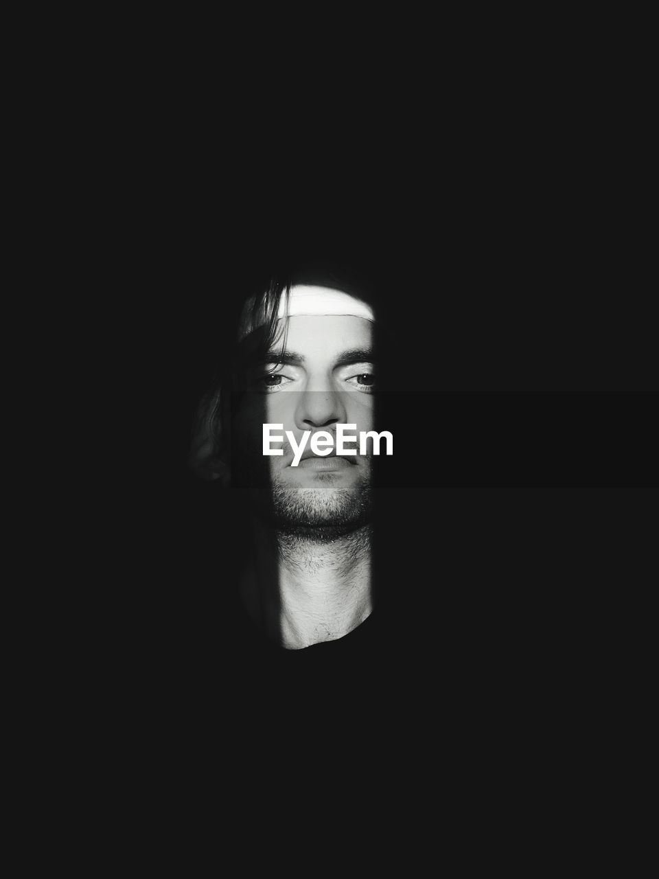 Portrait of man against black background