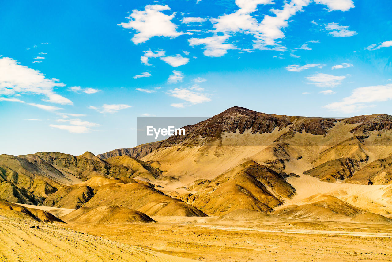 SCENIC VIEW OF MOUNTAIN RANGE AGAINST BLUE SKY