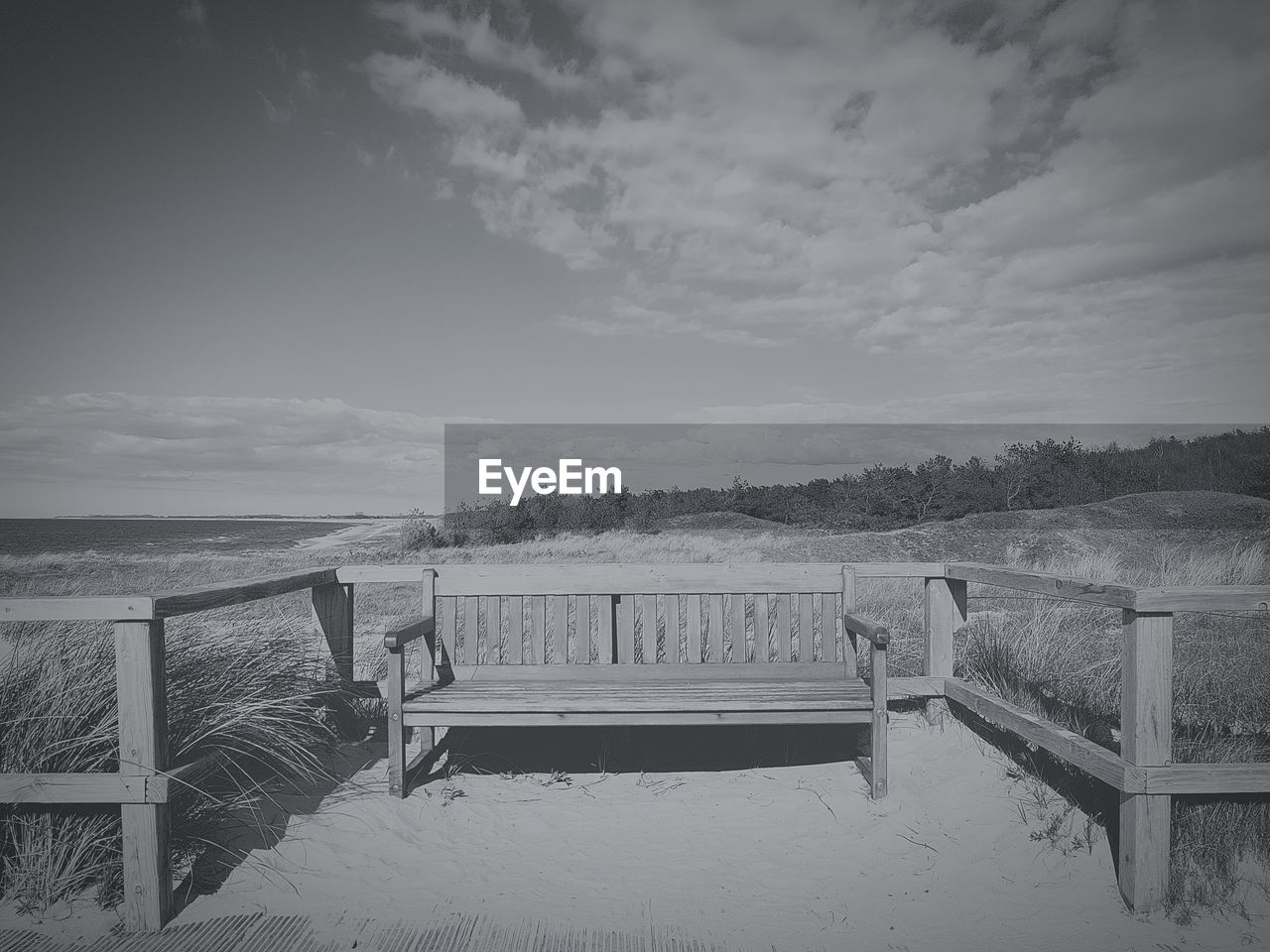 RAILING ON BEACH AGAINST SKY