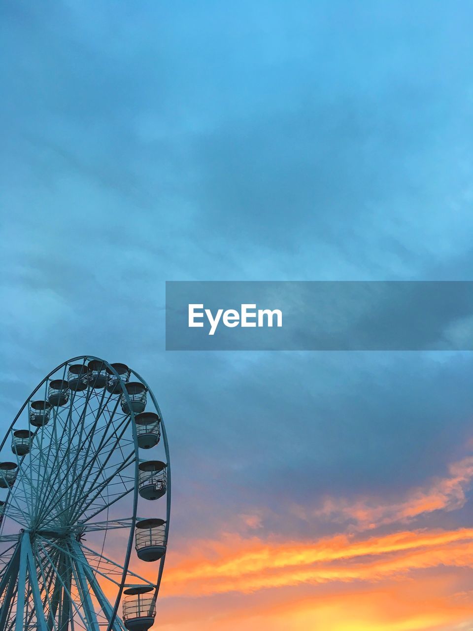 Low angle view of ferris wheel against sky