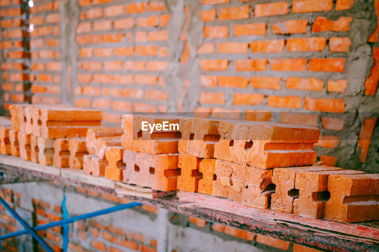 CLOSE-UP OF BRICK WALL WITH ORANGE WALLS