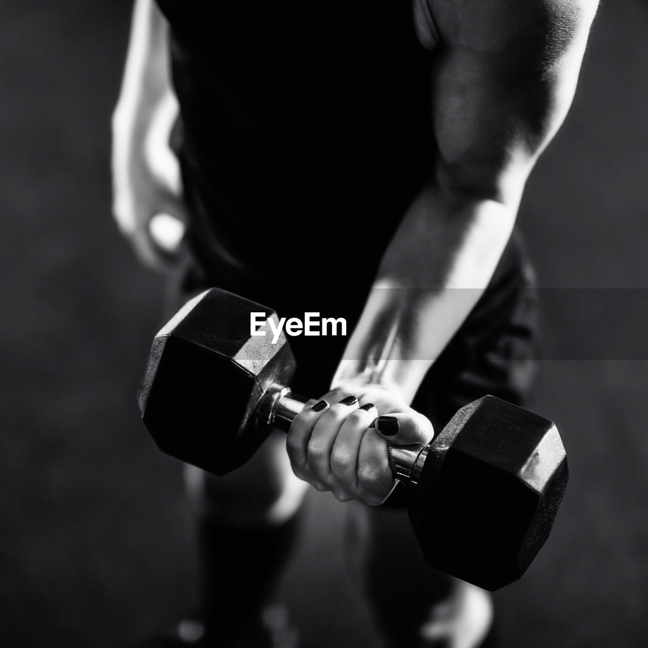 Cross training. young woman exercising with dumbbells