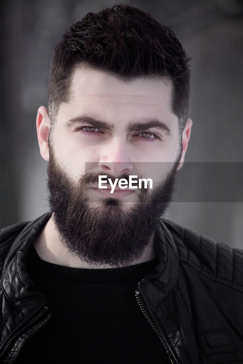 Portrait of bearded man standing outdoors during winter