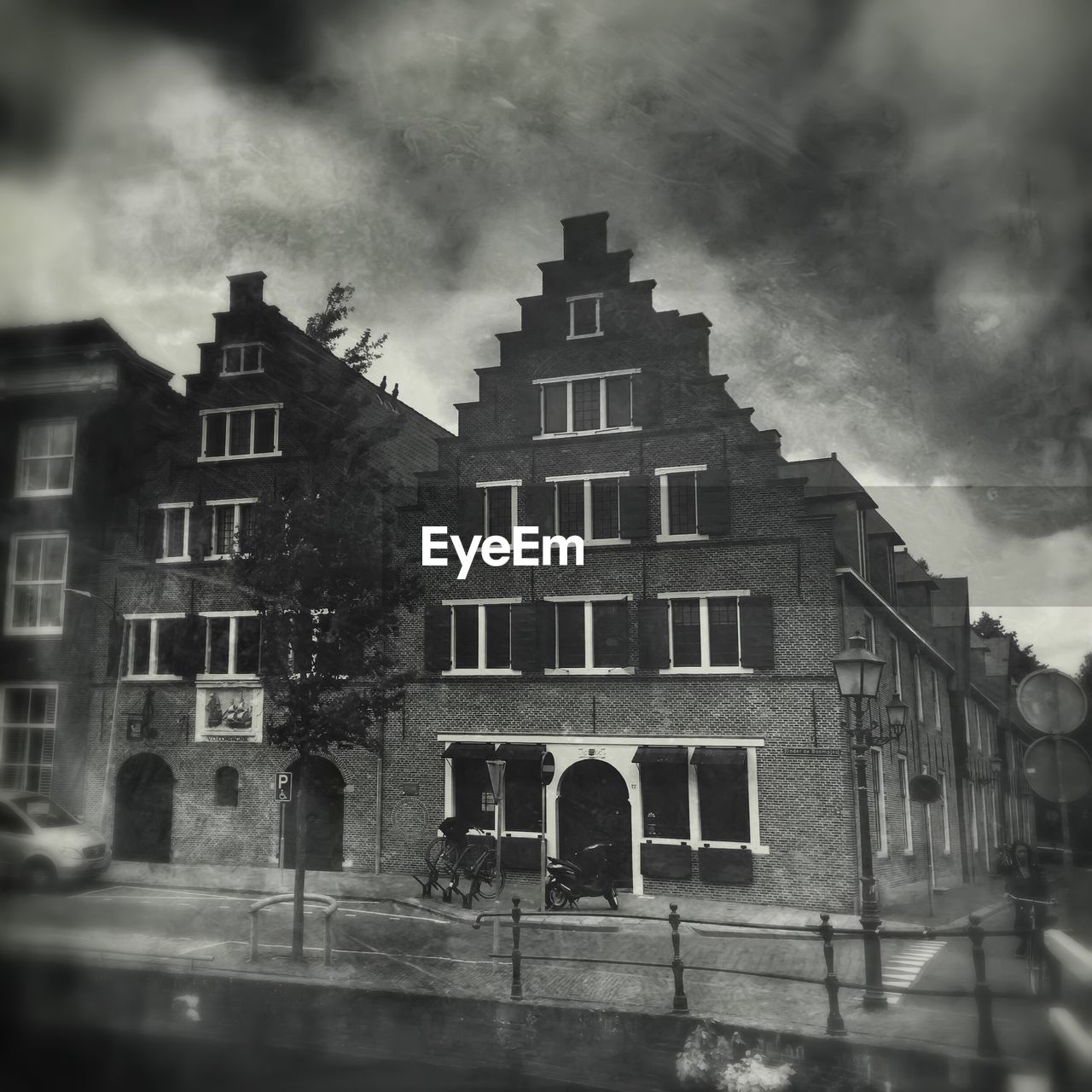 Buildings in city against cloudy sky