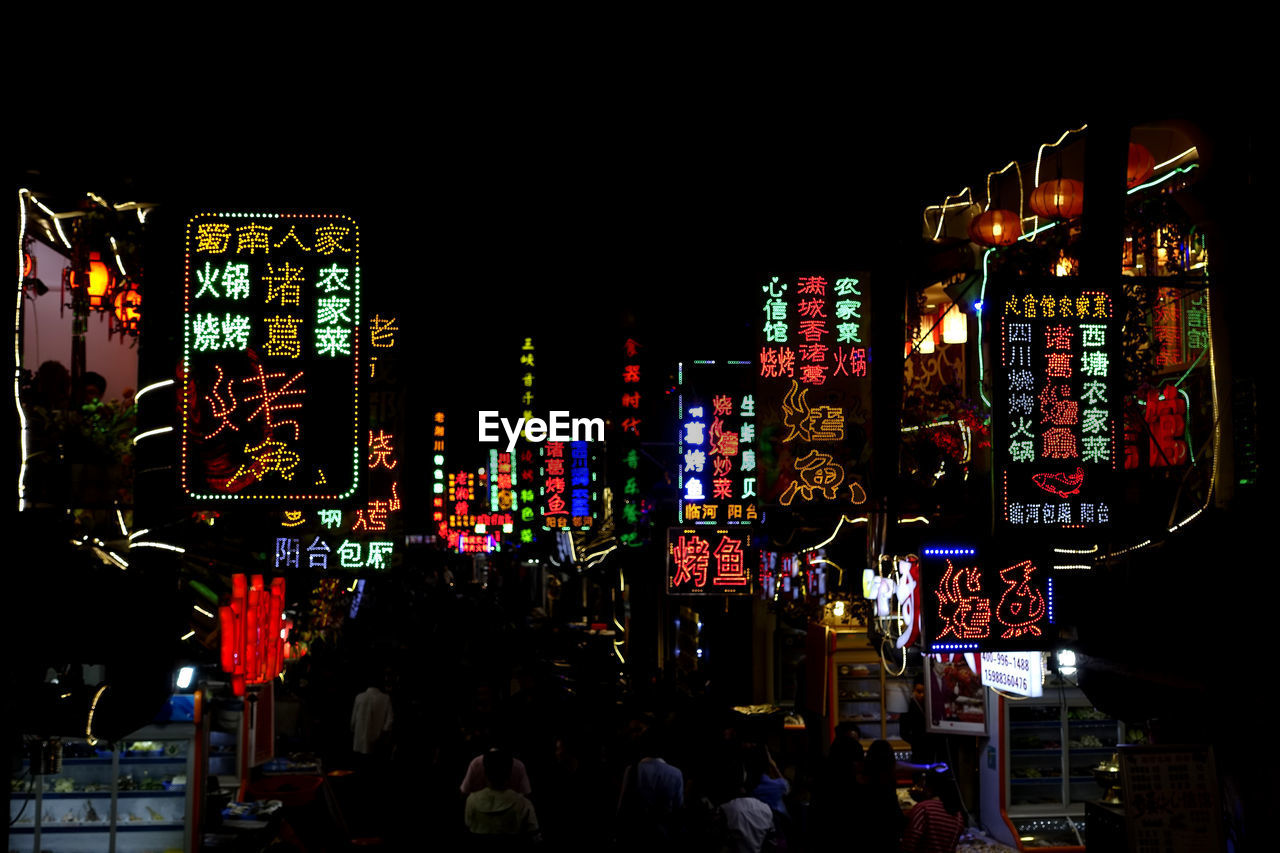 Illuminated information signs in city at night