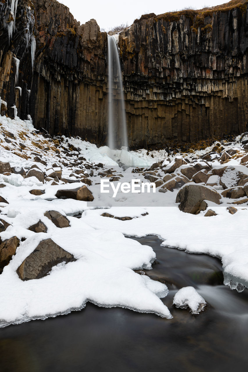 Iconic scenic svartifoss on a cold snowy winter day in iceland