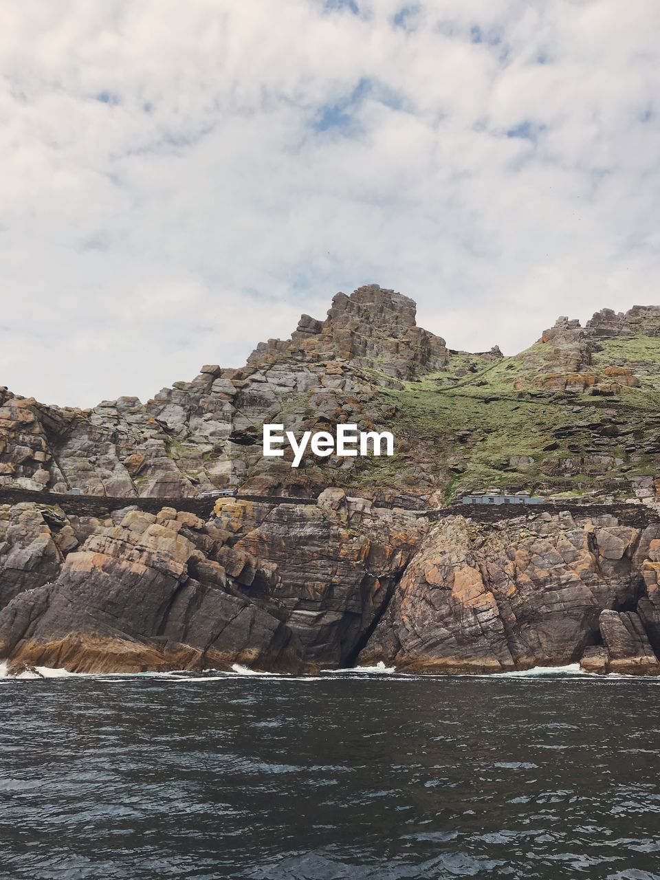 ROCK FORMATIONS ON SEA AGAINST SKY