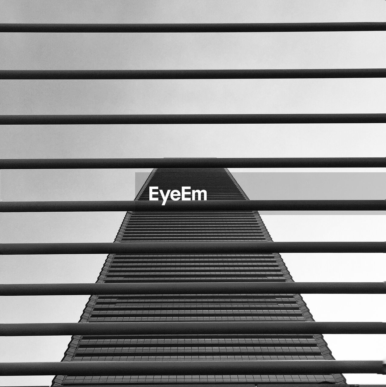 Low angle view of building against clear sky seen from window