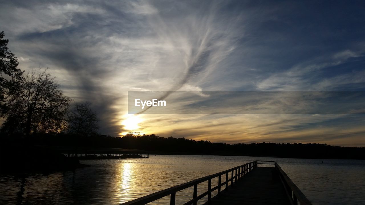 VIEW OF LAKE AGAINST CLOUDY SKY