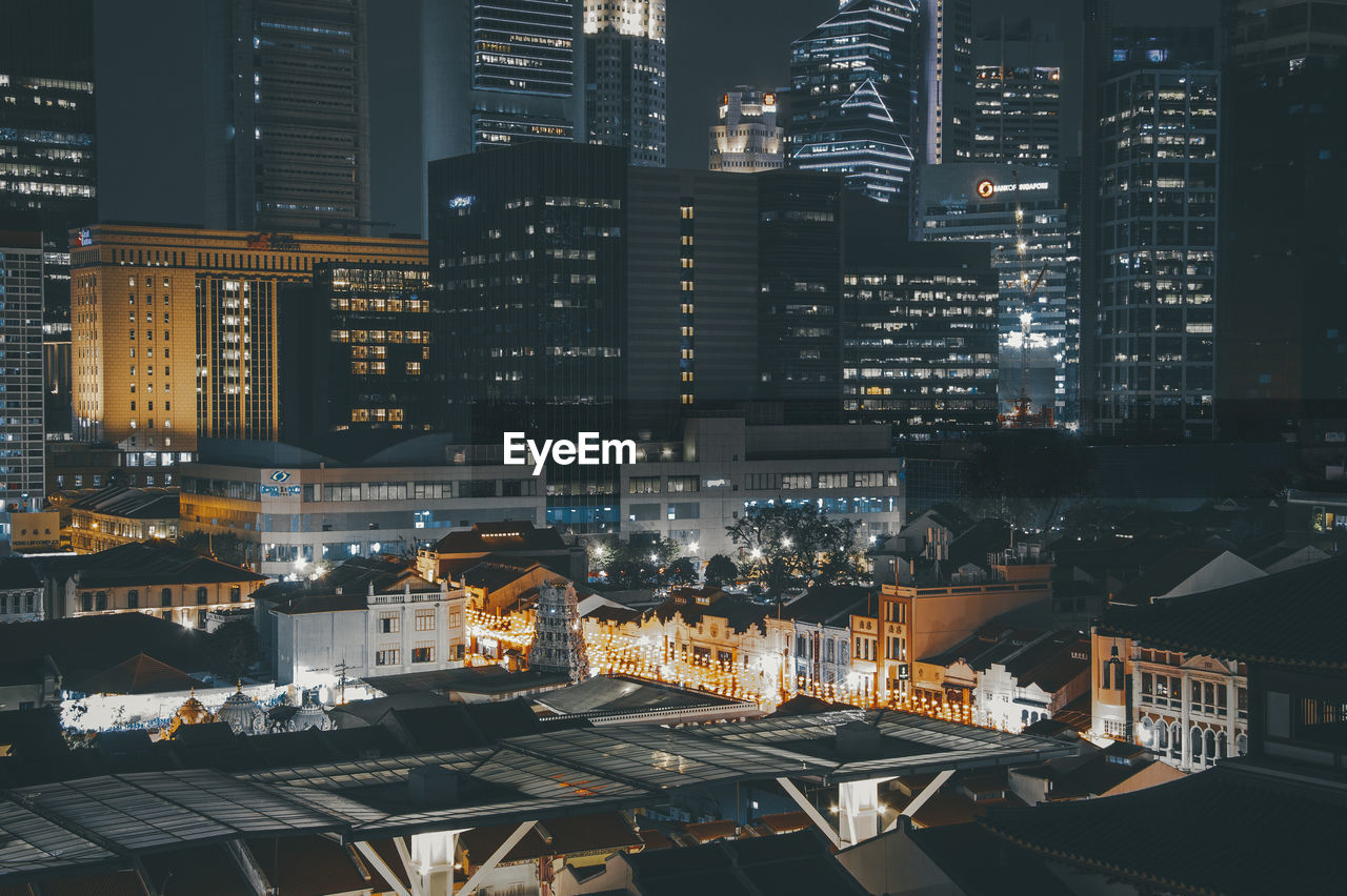 High angle view of illuminated buildings in city at night