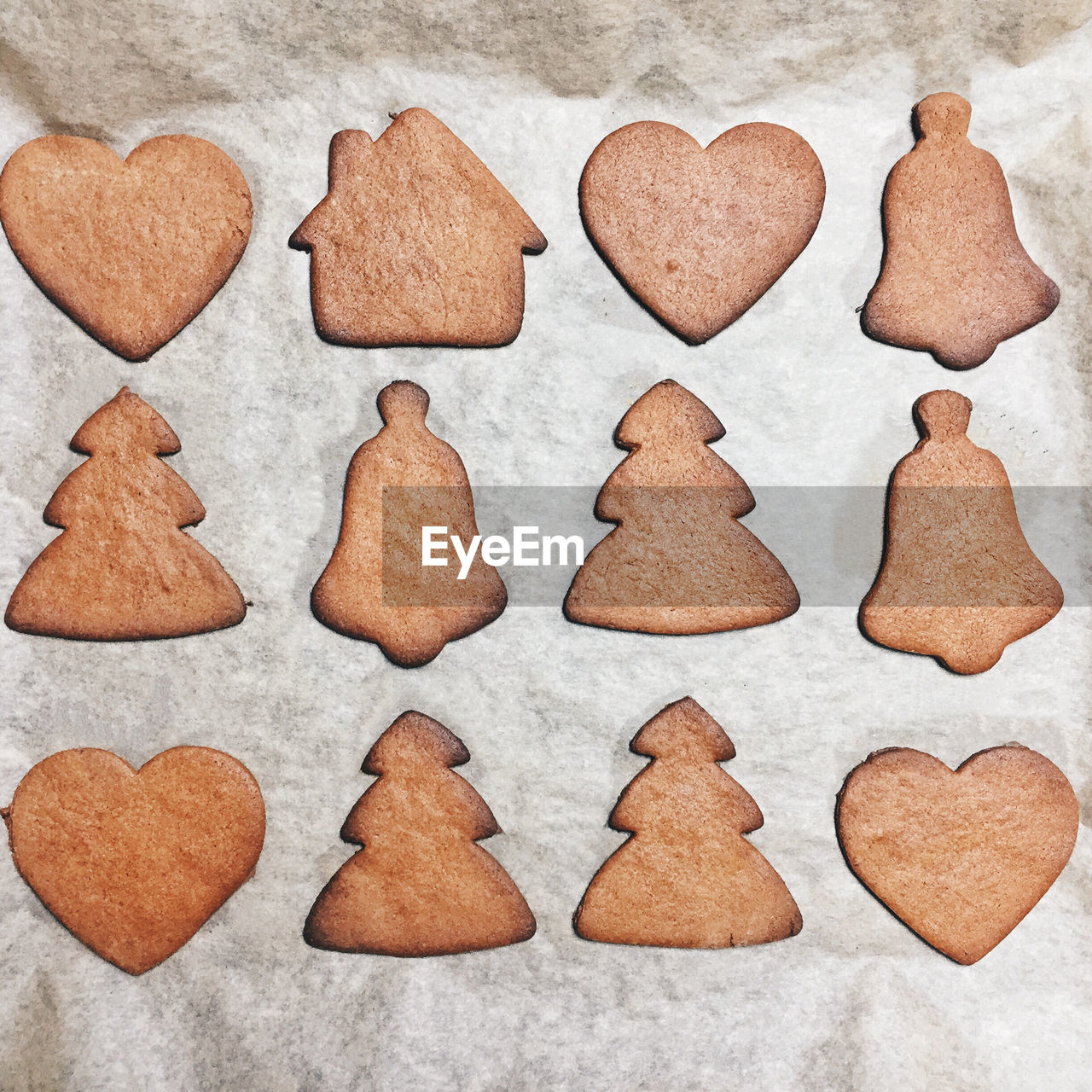 Directly above view of gingerbread cookies arranged on baking sheet