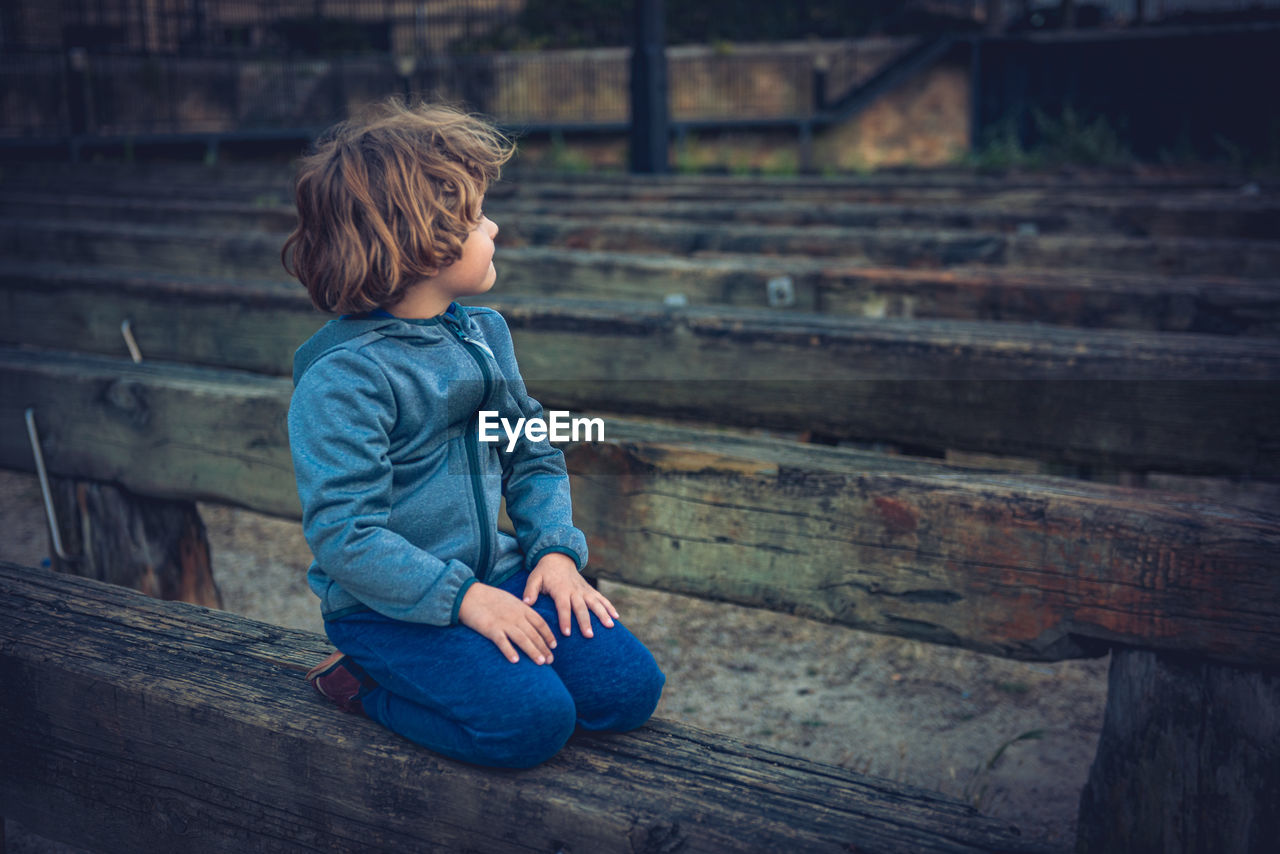 Young boy contemplating sunset in time ramp