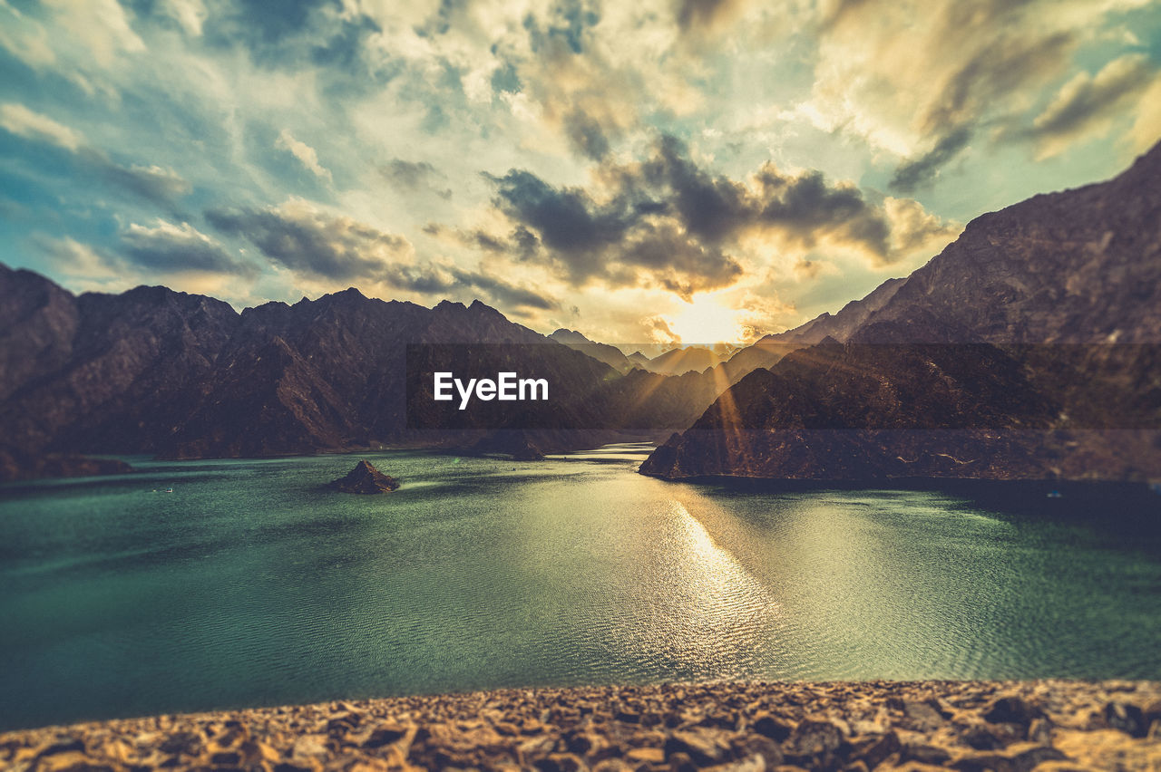 Scenic view of lake and mountains during sunset