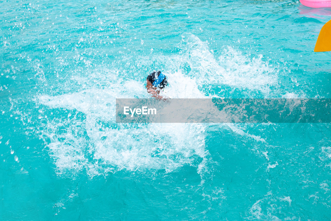 High angle view of boy splashing water in park