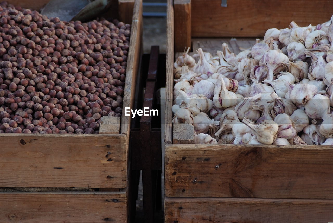 High angle view of garlic and chestnuts for sale at market stall