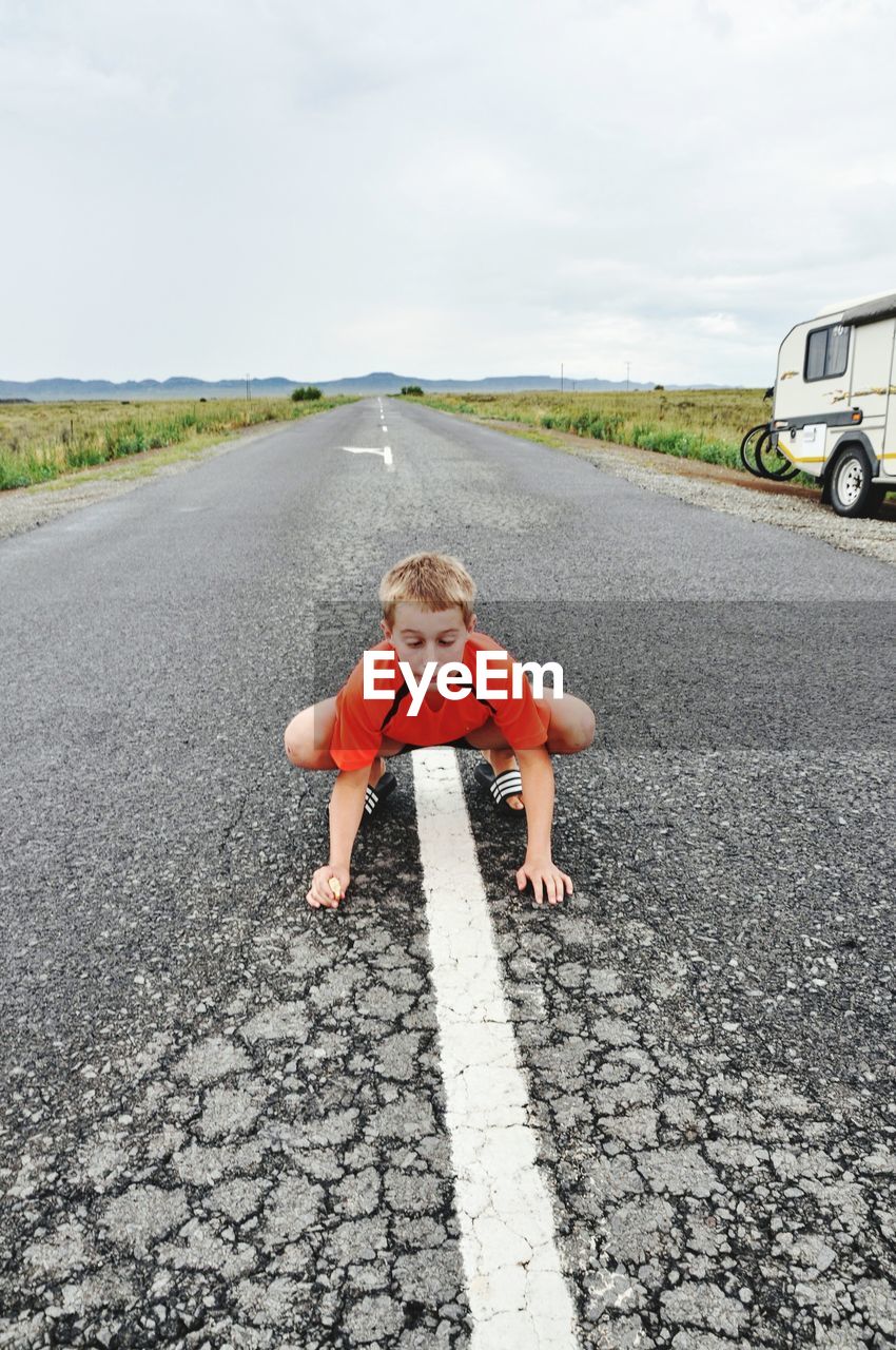 BOY STANDING ON ROAD