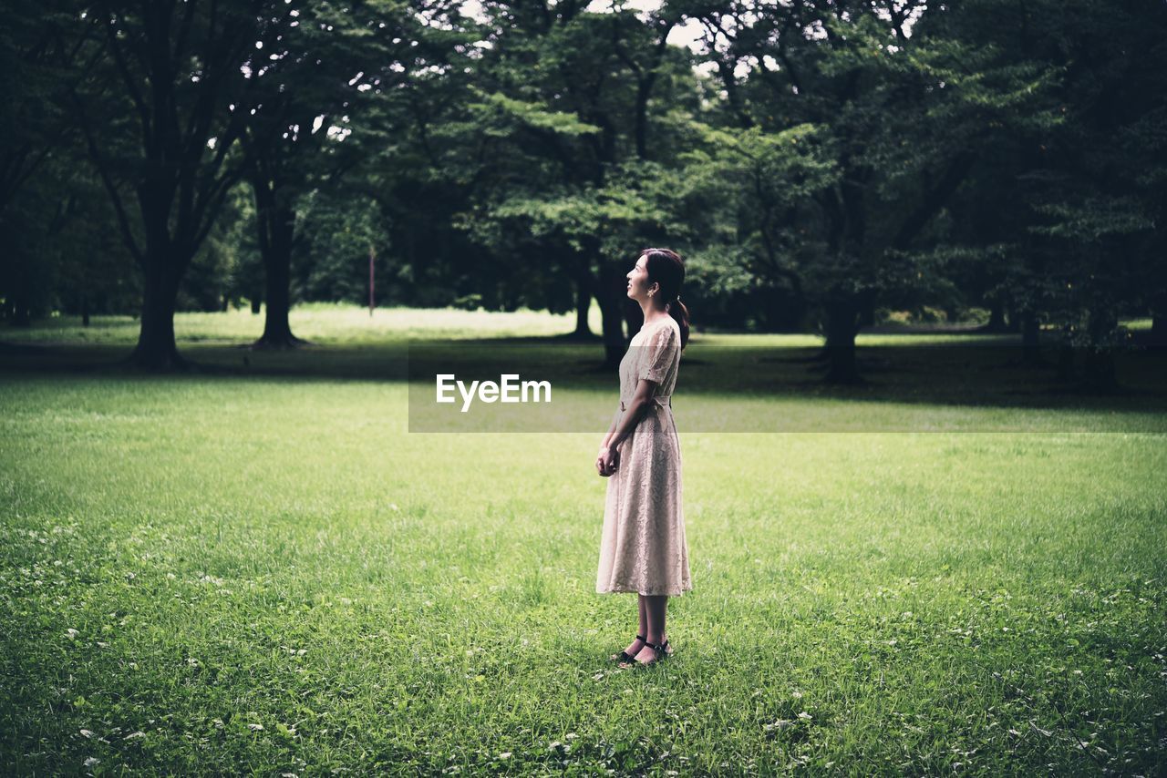 Full length of woman standing on field