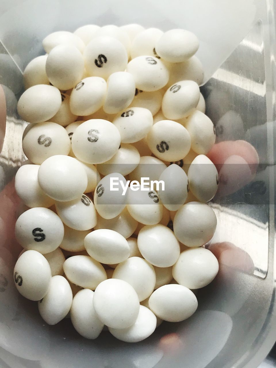 HIGH ANGLE VIEW OF EGGS ON WHITE CONTAINER