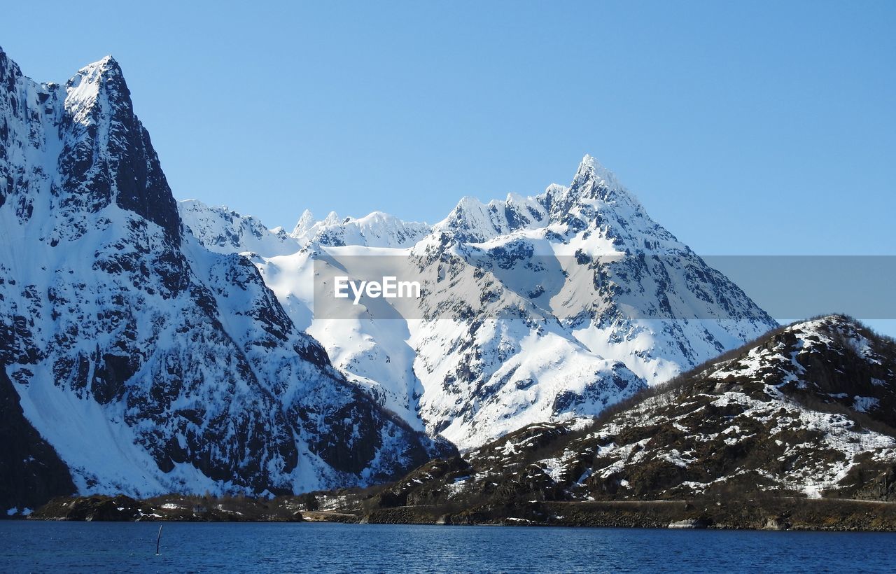 SNOWCAPPED MOUNTAINS AGAINST CLEAR BLUE SKY