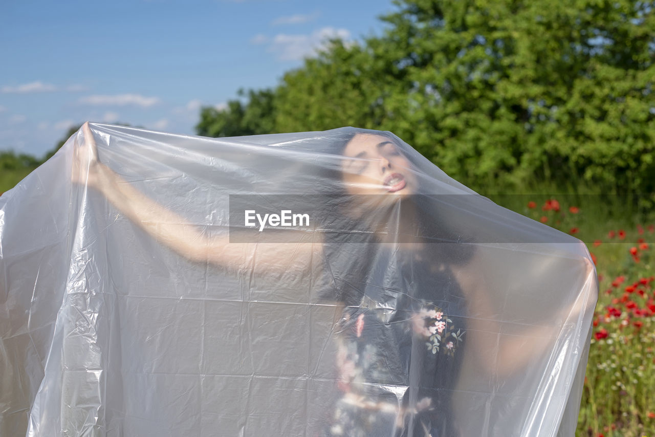 rear view of woman with umbrella against trees