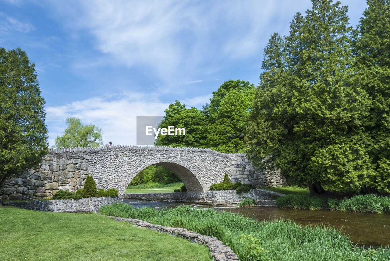 View of medieval bridge against cloudy sky