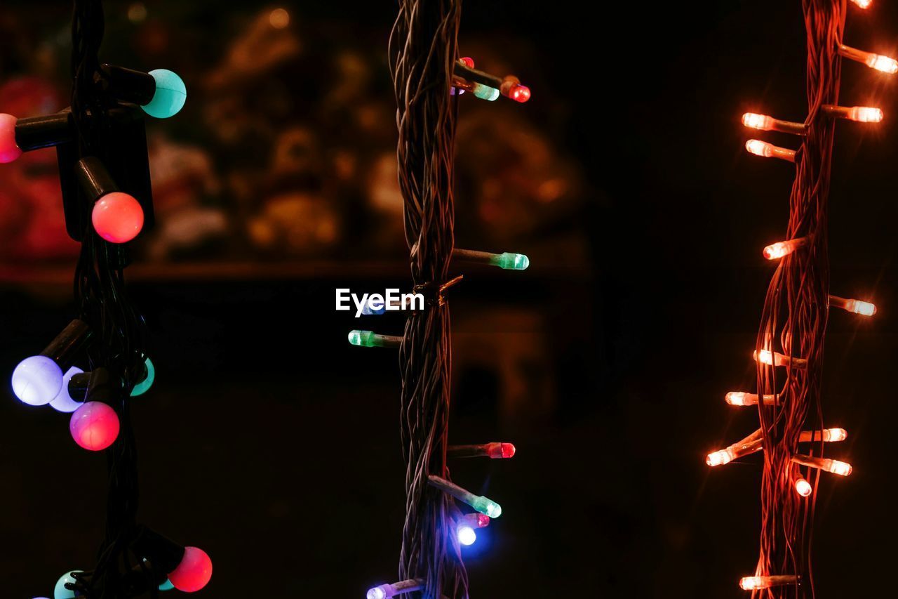 Close-up of illuminated string lights hanging at night