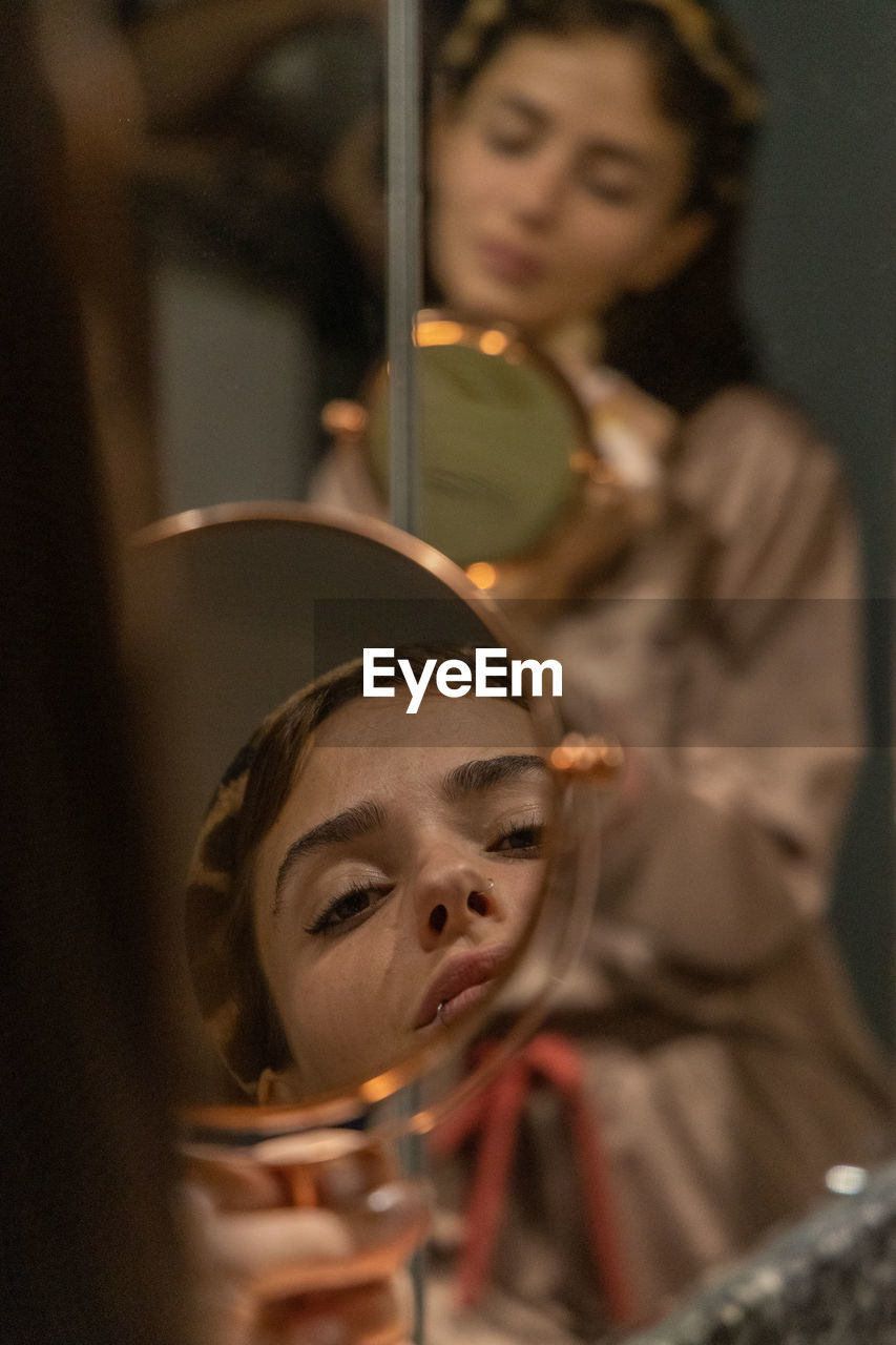 Portrait reflexión of young woman in bathroom