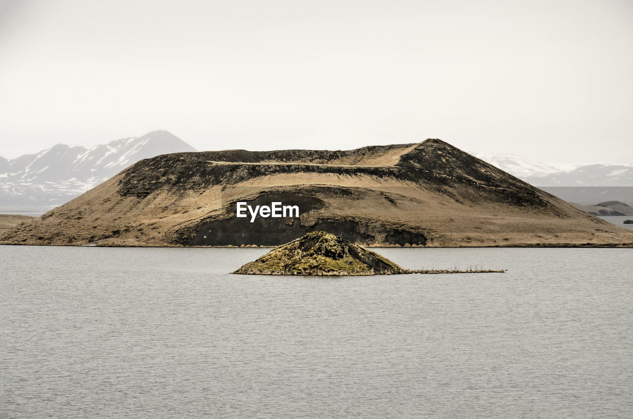 View across lake myvatn in iceland towards one of the well-known pseudocraters and a little island