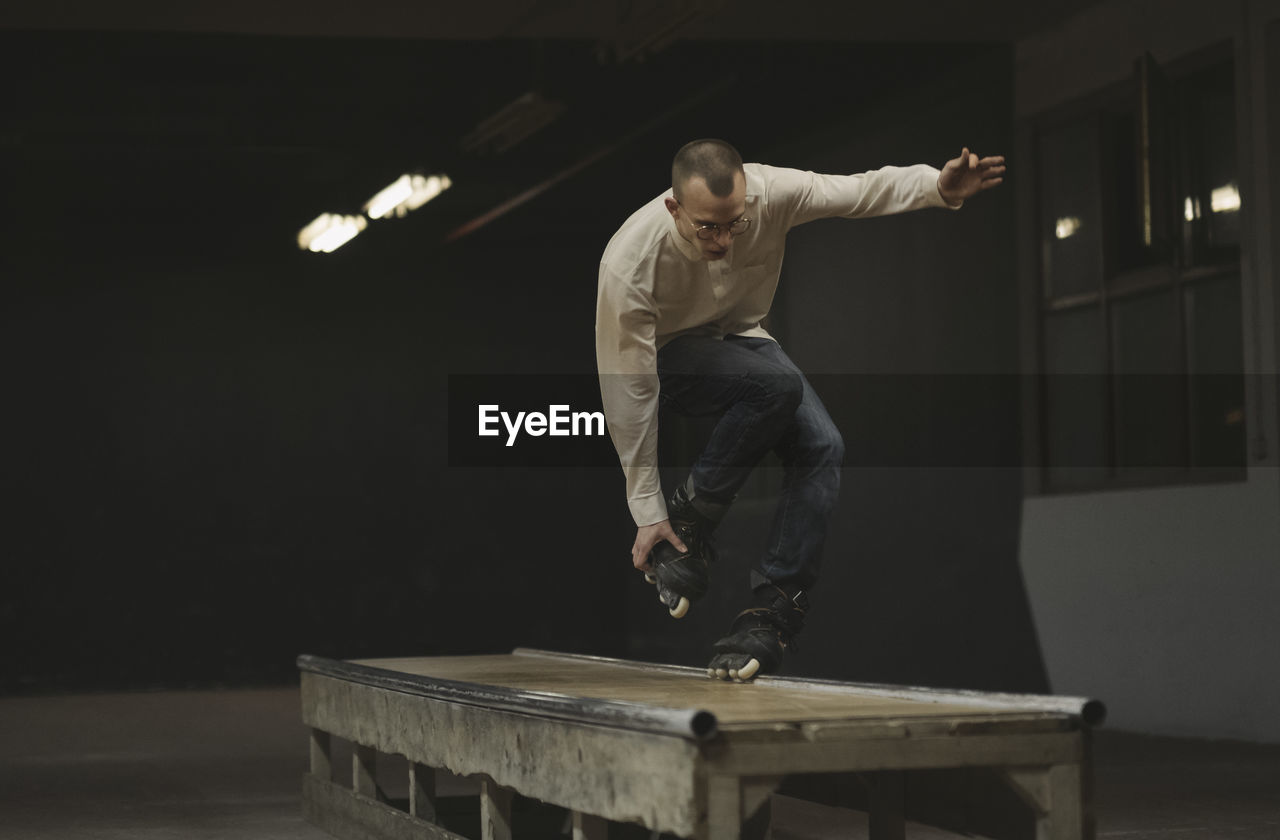 Man inline skating on table