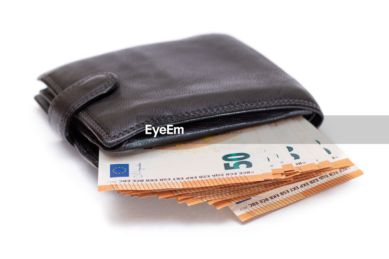 finance, business, currency, cut out, wealth, wallet, paper currency, fashion accessory, white background, studio shot, savings, brown, no people, indoors, business finance and industry, leather, bag, textile