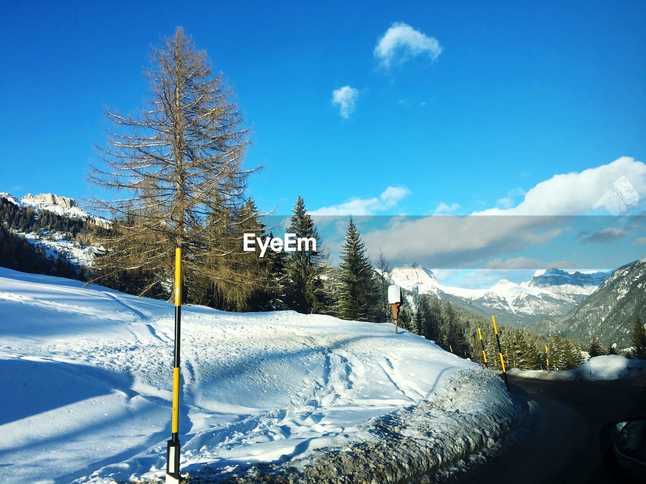 Scenic view of snow mountains against blue sky