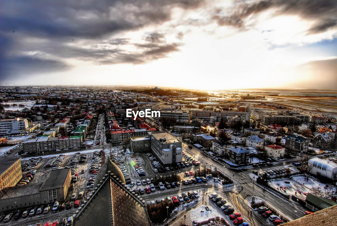 HIGH ANGLE VIEW OF CITY STREET AGAINST SKY