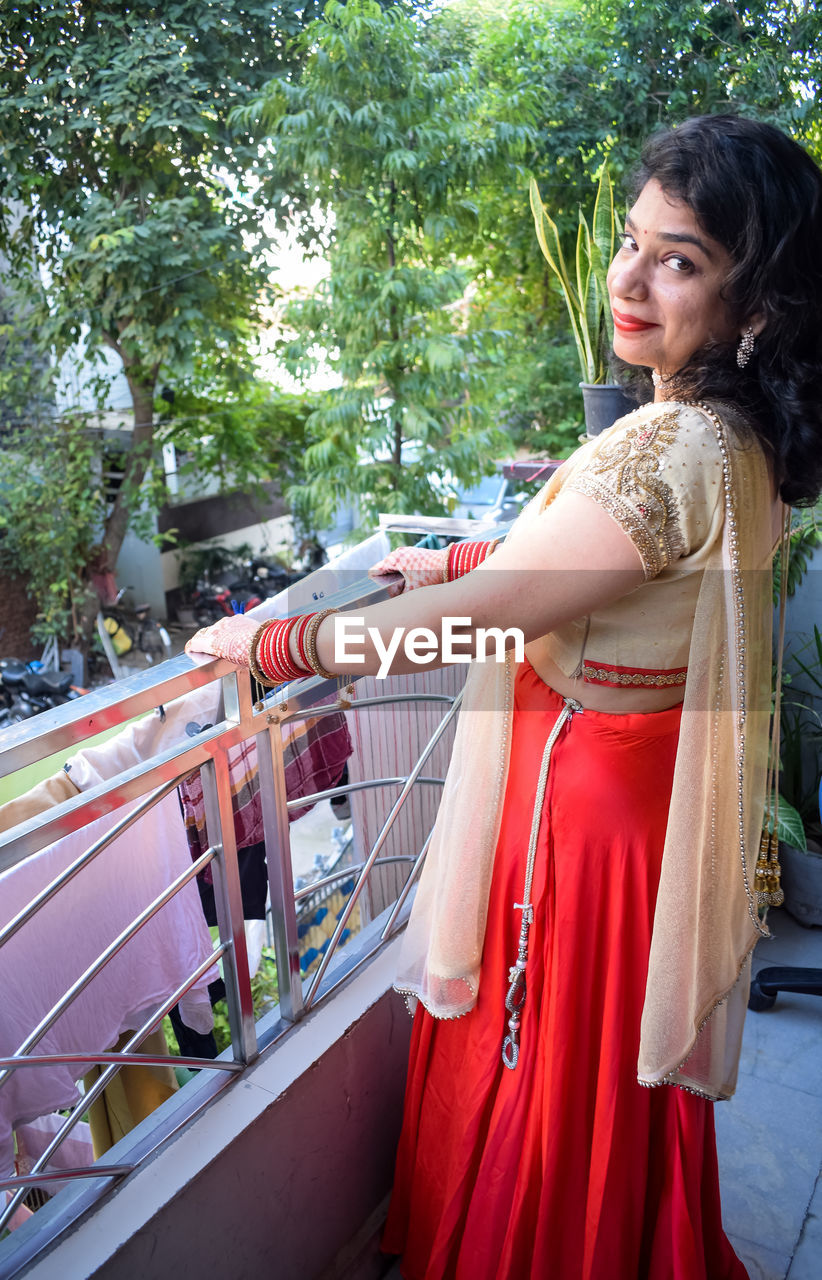 Beautiful woman dressed up as indian tradition with henna mehndi design on her both hands