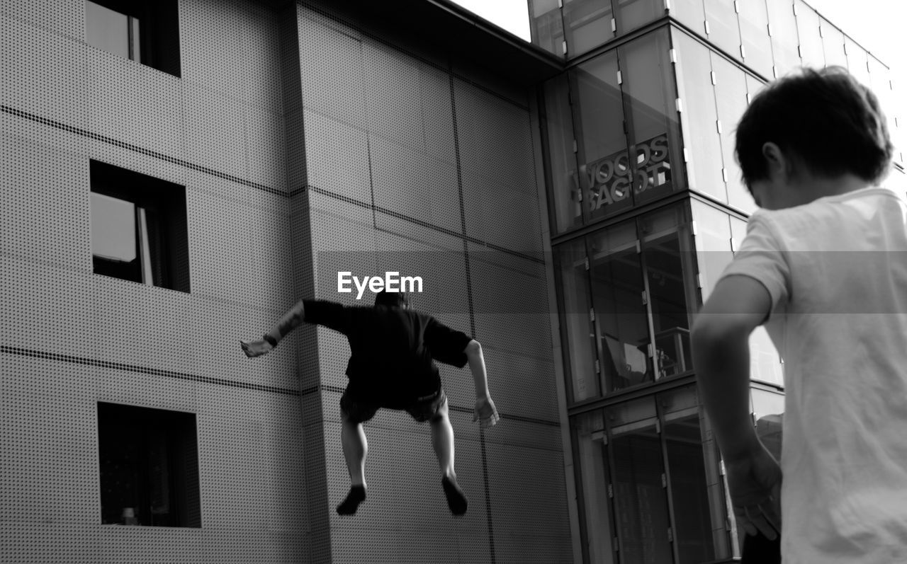 LOW ANGLE VIEW OF CHILDREN PLAYING IN BUILDING