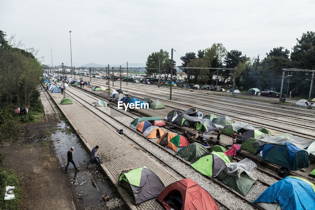 High angle view of refugee camp tents amidst railroad tracks