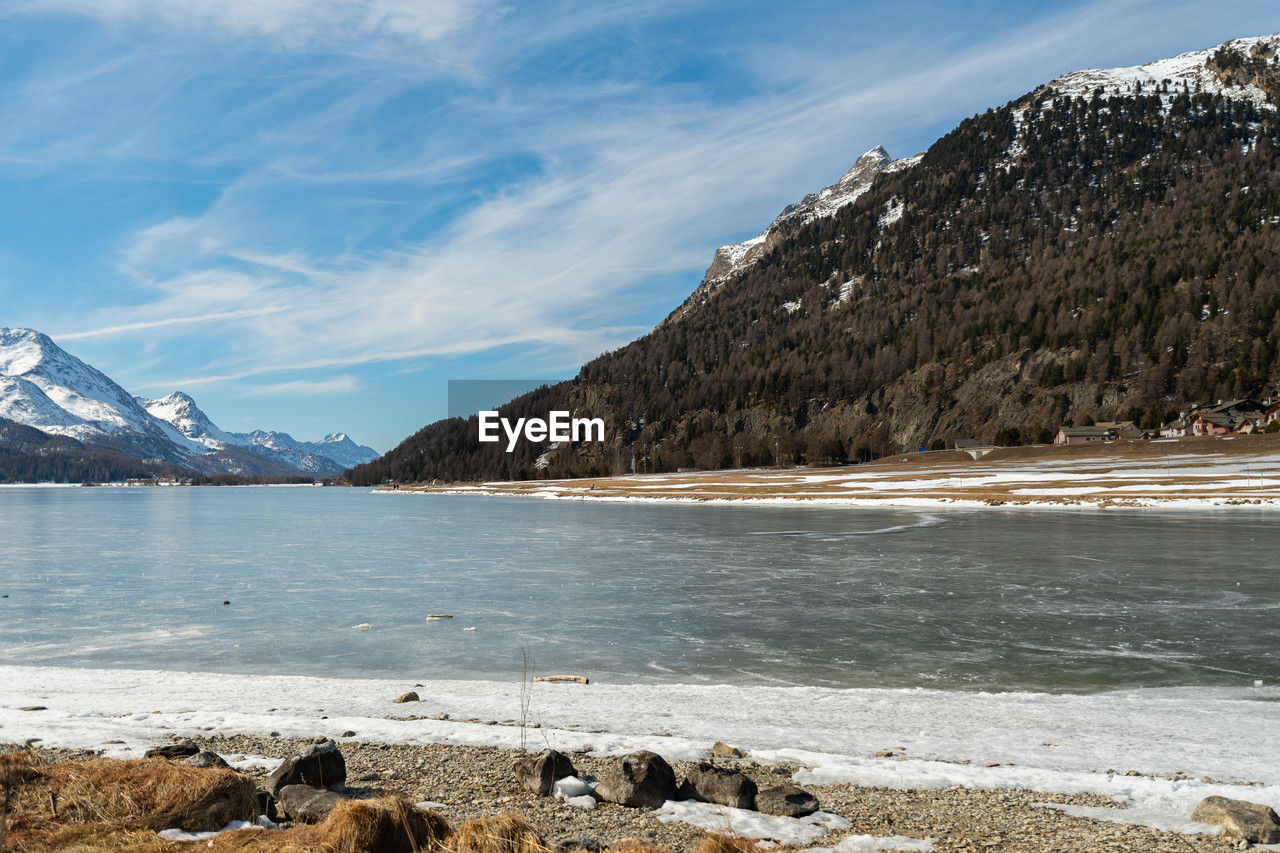 Silvaplana, switzerland, february 21, 2023 winter landscape scenery with a frozen lake of silvaplana