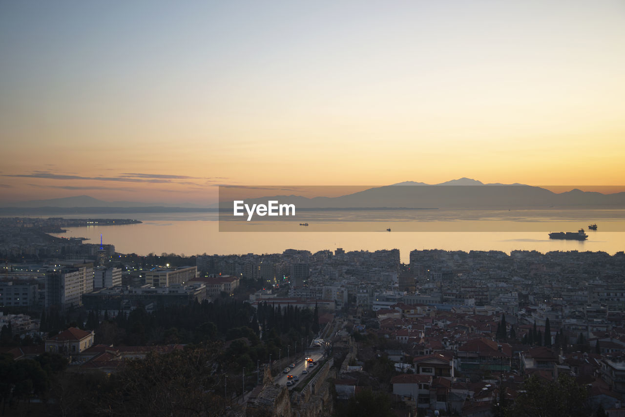 High angle view of buildings in city against sky during sunset