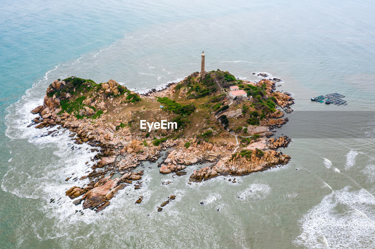 HIGH ANGLE VIEW OF ROCKS ON SHORE AT SEA