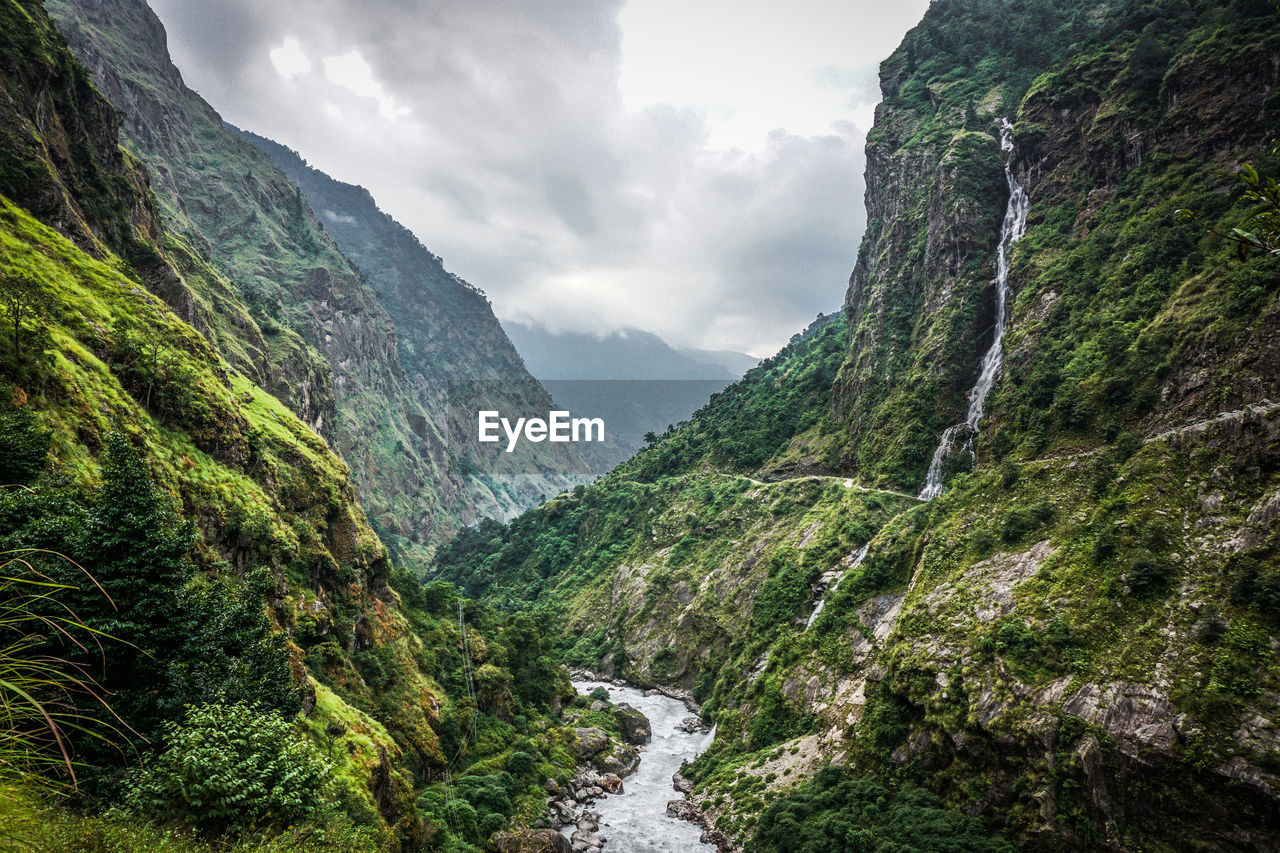 Scenic view of waterfall against sky