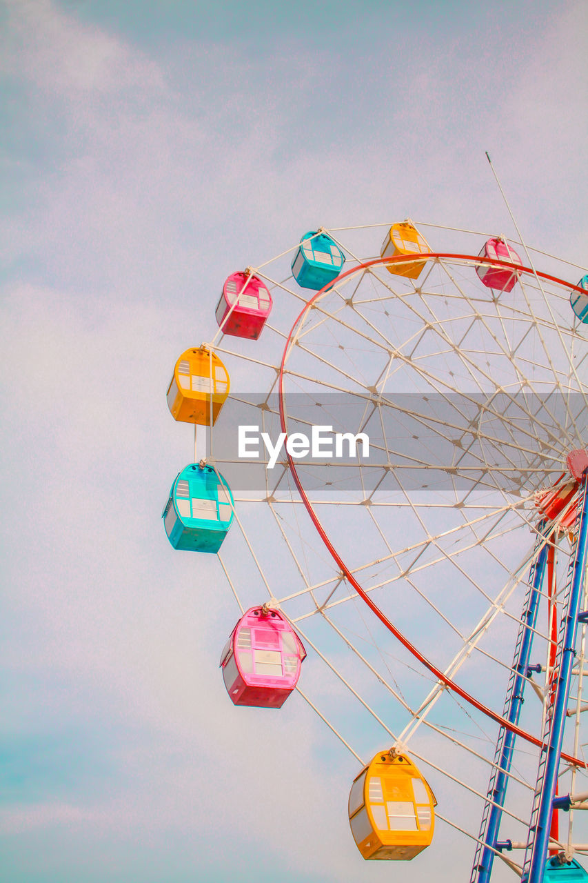 Low angle view of ferris wheel against sky