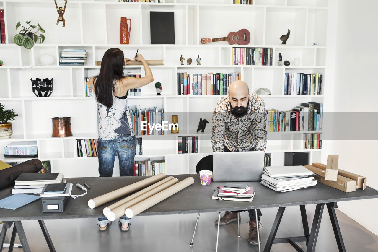 Male and female architects working at home office
