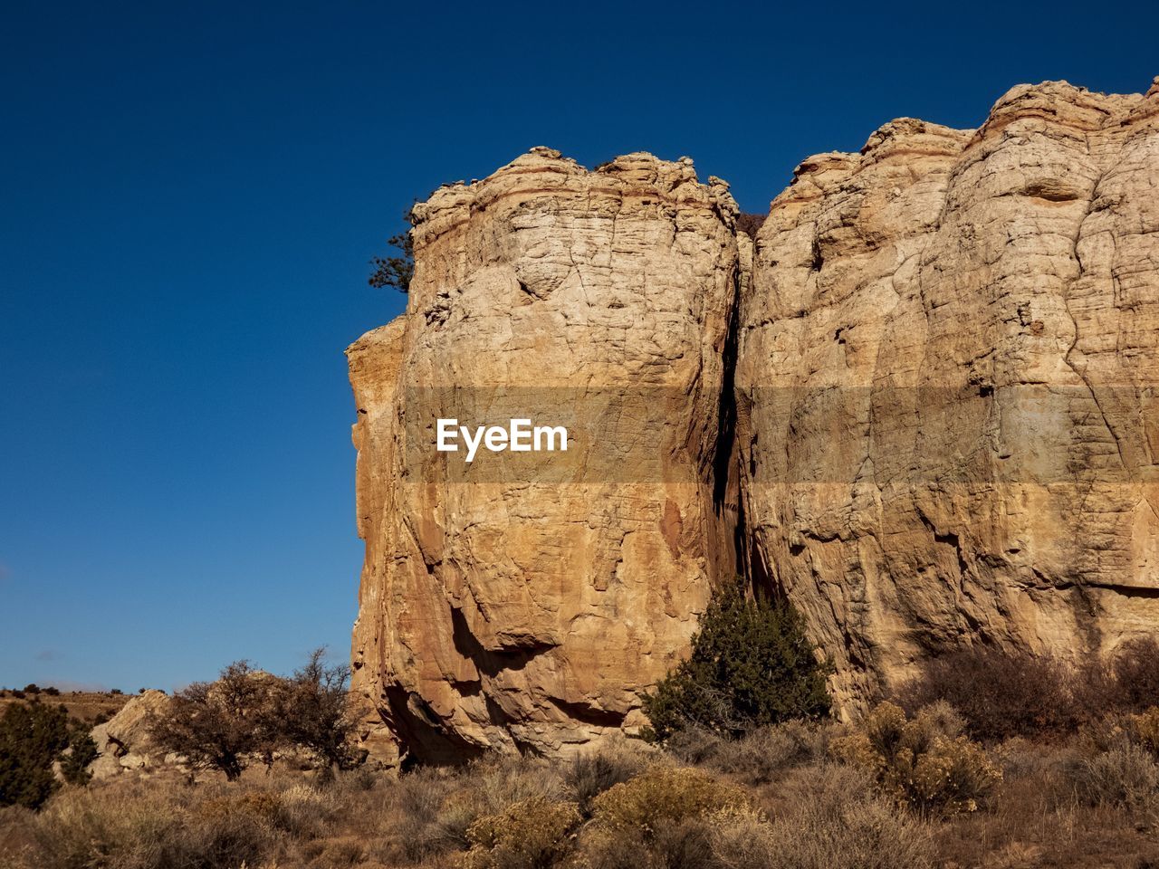 Low angle view of rock formations  suggesting human characteristics against sky