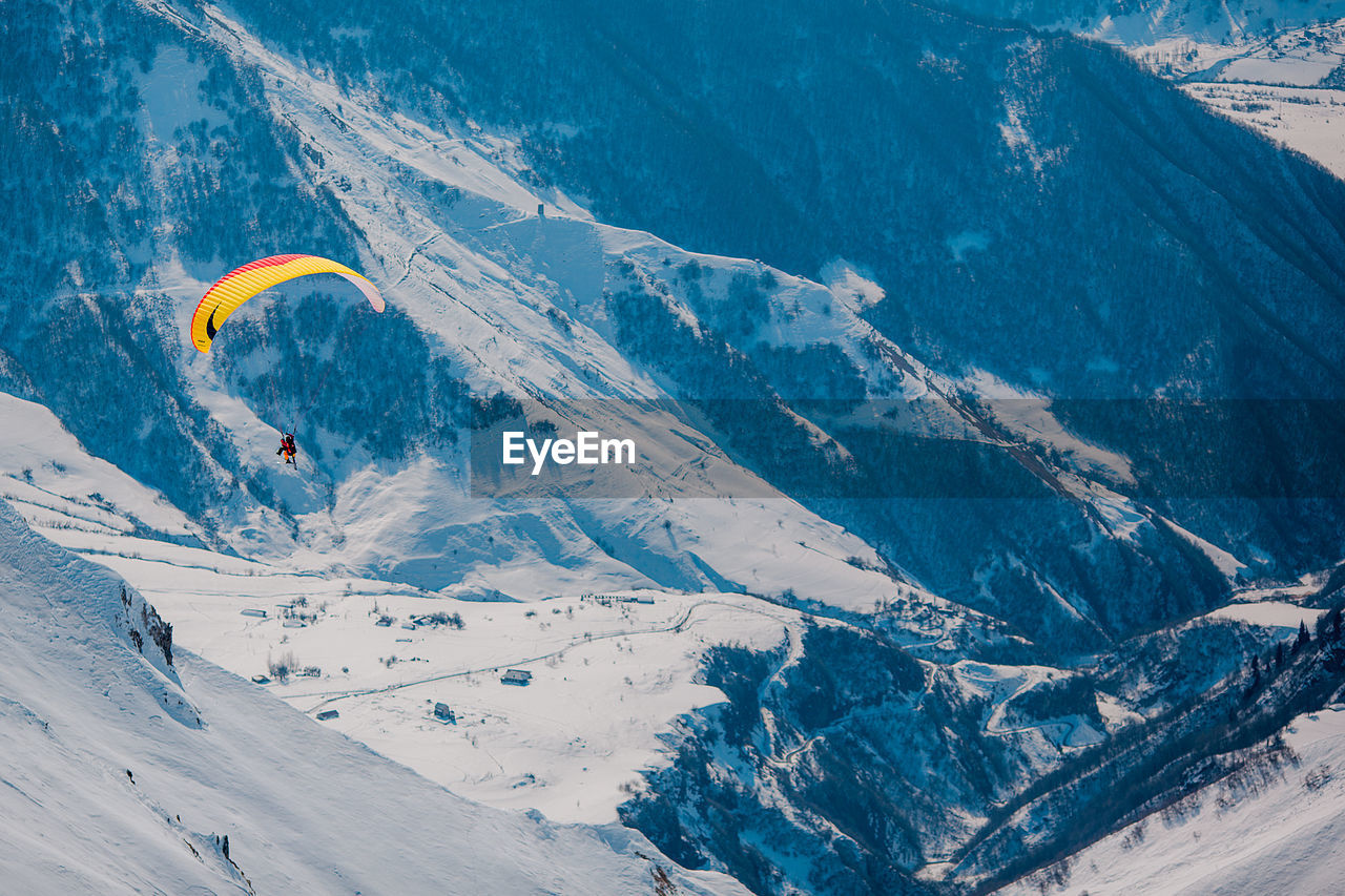 AERIAL VIEW OF SNOWCAPPED MOUNTAINS