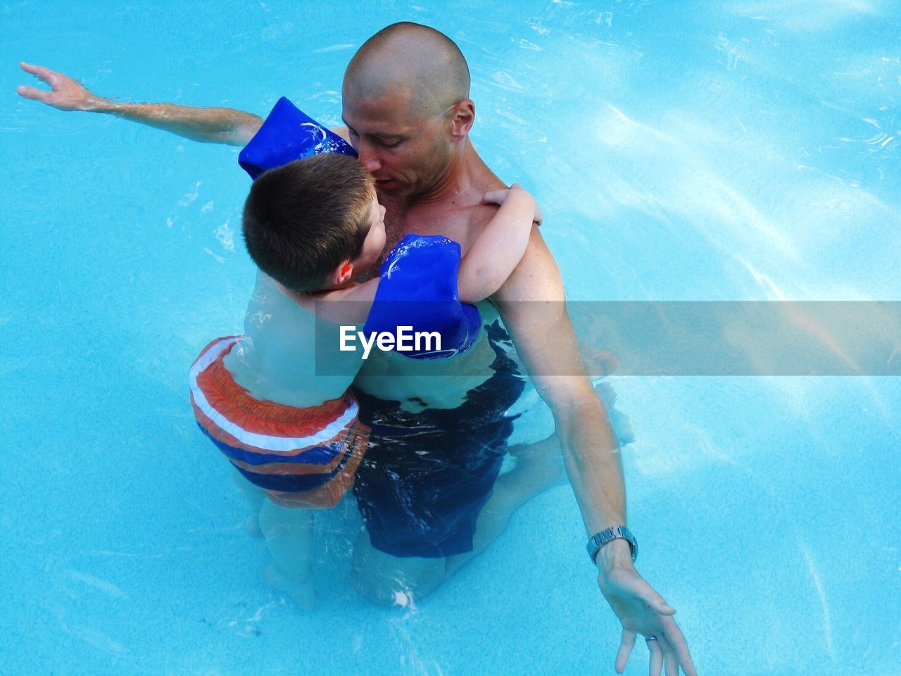 Boy and father in water