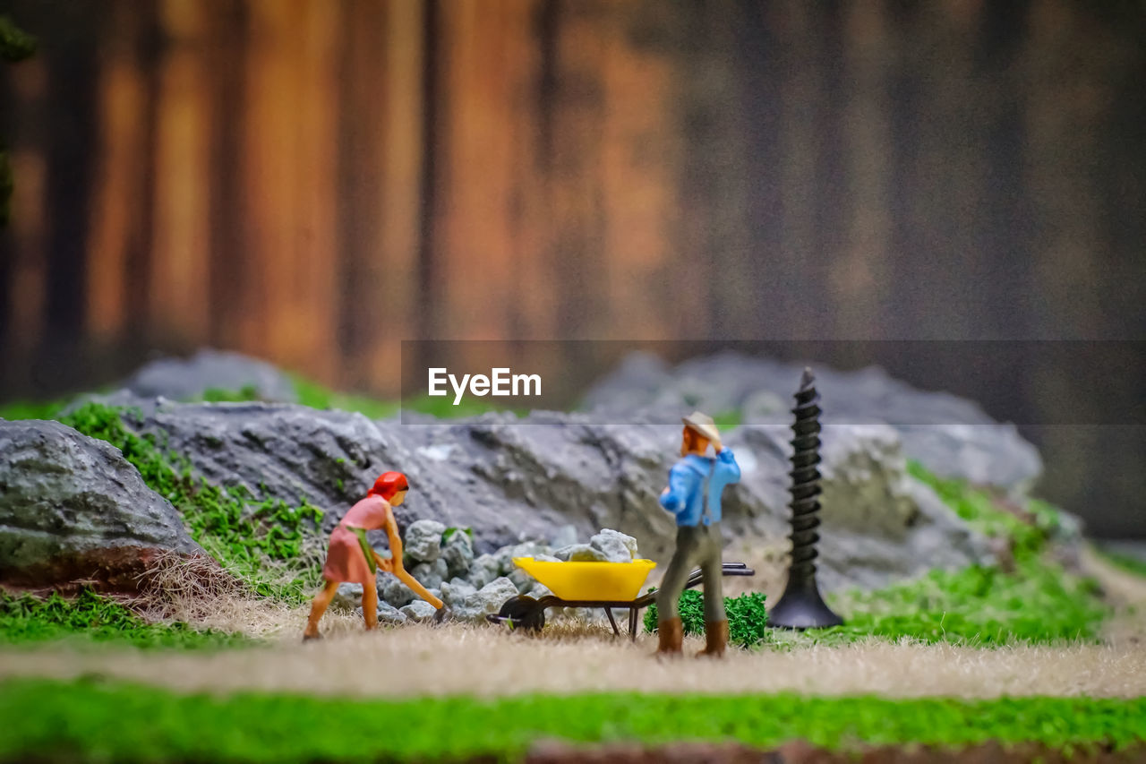 CHILDREN PLAYING WITH TOY IN FIELD