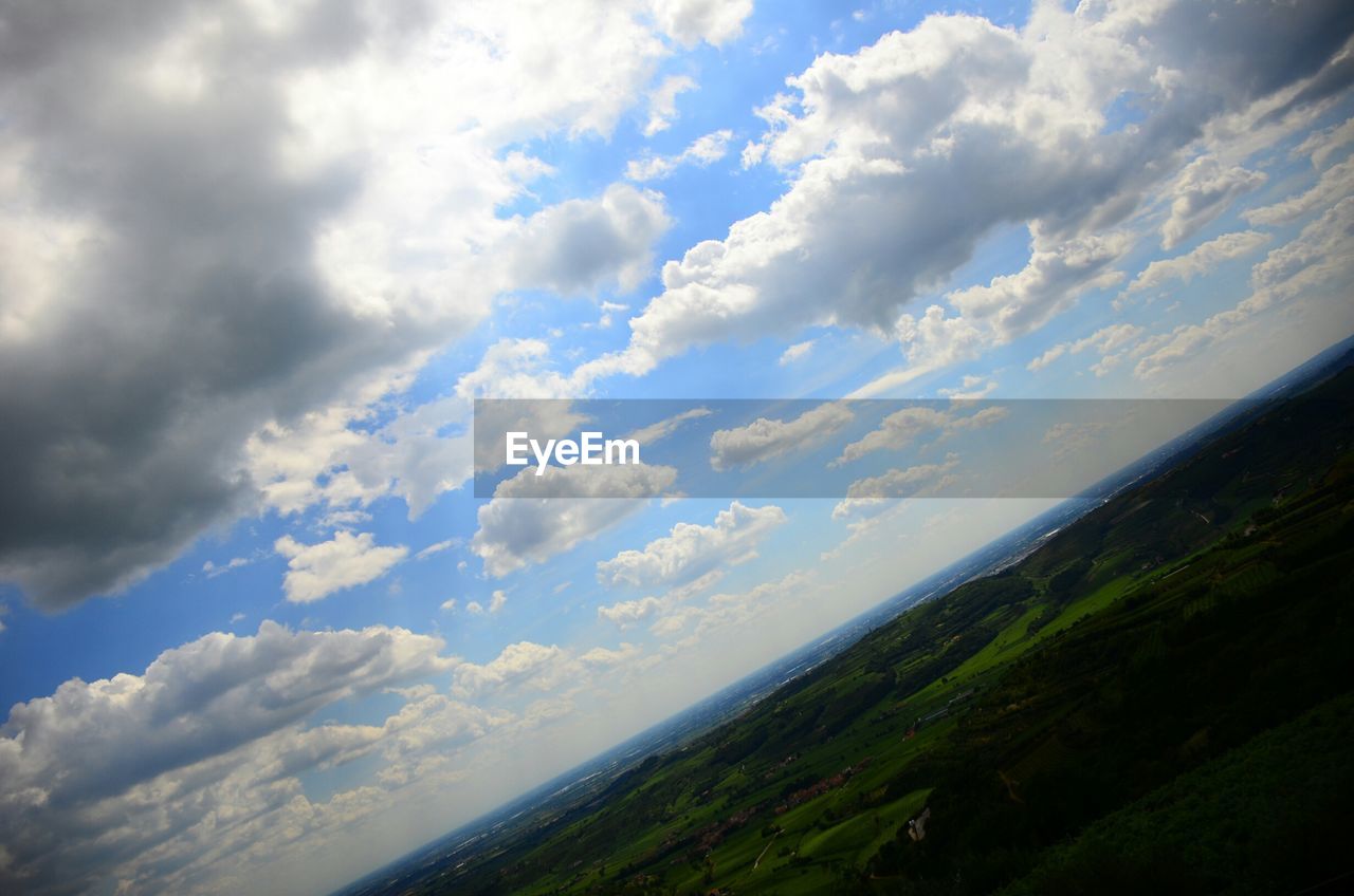 SCENIC VIEW OF MOUNTAINS AGAINST CLOUDY SKY