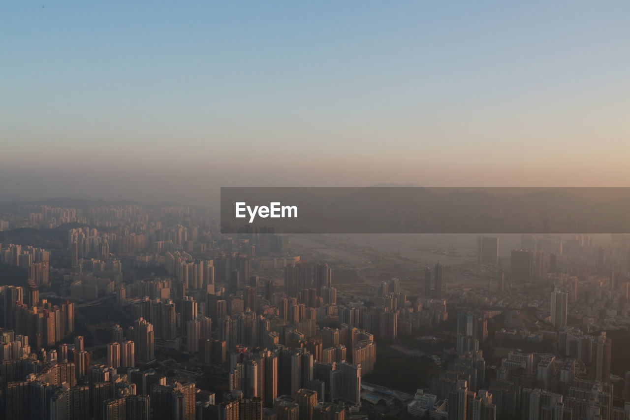 High angle view of buildings in city against clear sky